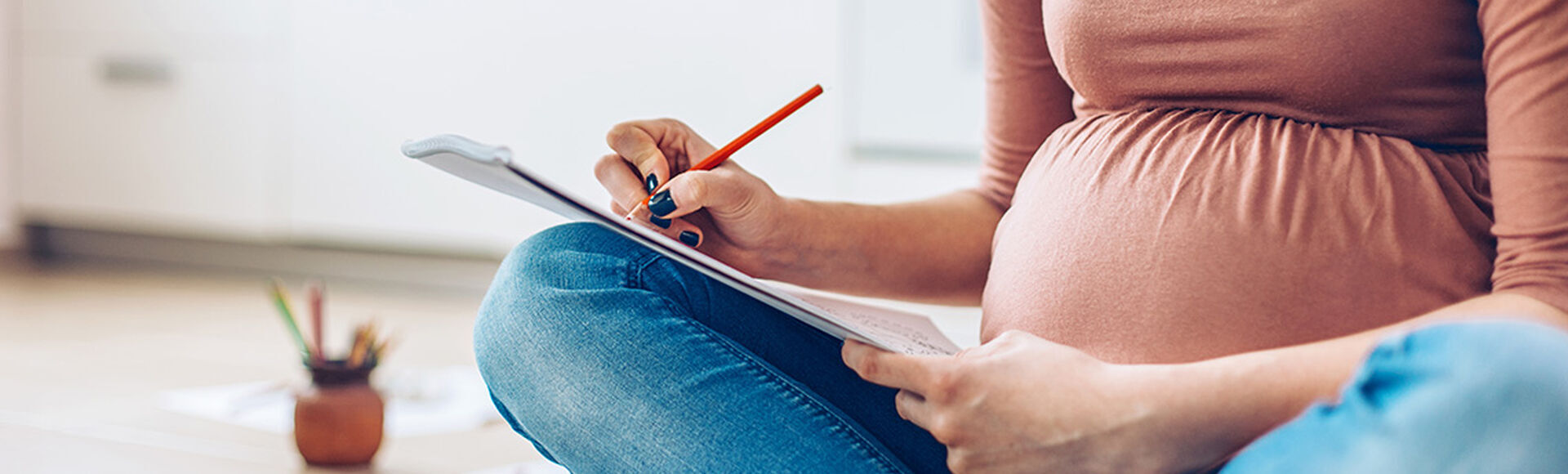 mujer embarazada tomando notas